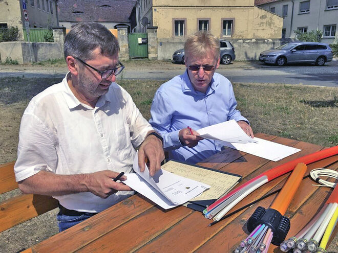 Jörg Hänisch, Bürgermeister der Gemeinde Moritzburg (li.) und Kai Gärtner von der Telekom an der historischen Milchrampe bei der Unterzeichnung der Ausbauerklärung